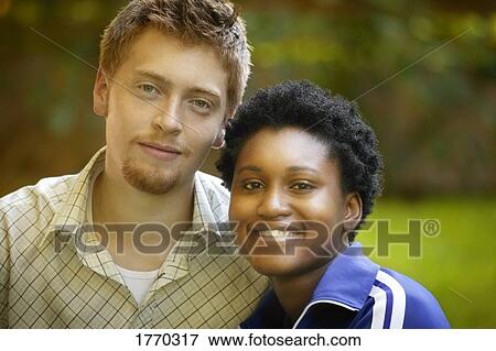 Stock Photo - Happy interracial young couple. Fotosearch