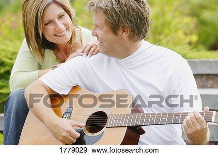 Man plays a guitar View Large Photo Image Stock Photo - Man plays a guitar. Fotosearch