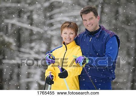 Stock Photography - Portrait of a couple with skis. Fotosearch