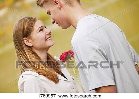 Stock Photo - Presenting a flower. Fotosearch