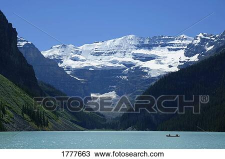 A mountain range with a lake in the foreground View Large Photo Image Stock Image - A mountain range with a lake in the foreground. Fotosearch