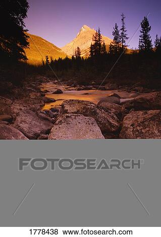 A stream with mountains in the background View Large Photo Image Stock Photo - A stream with mountains in the background. Fotosearch