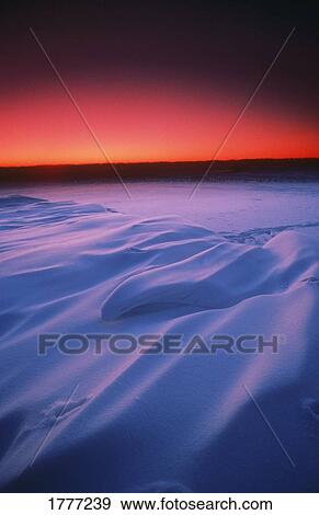 Stock Photo - Colourful snowscape and sunset. Fotosearch
