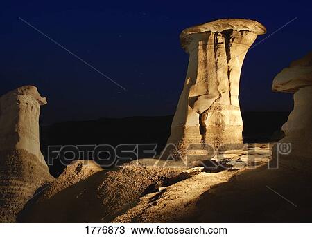 Stock Image - Unusual rock formations against a night sky. Fotosearch