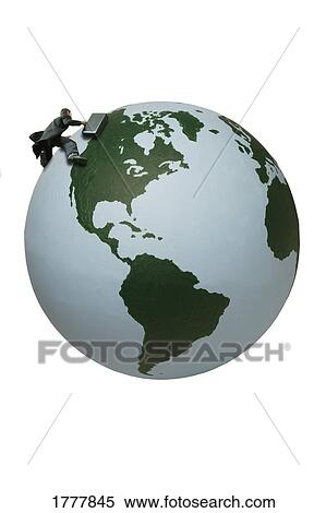 Stock Photography - A businessman trying to conquer the earth. Fotosearch