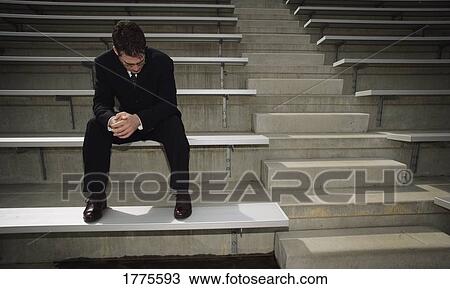 Businessman alone in a stadium View Large Photo Image Stock Image - Businessman alone in a stadium. Fotosearch