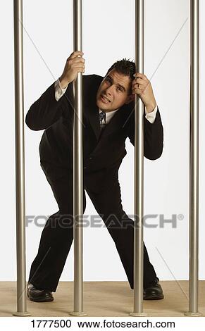 Businessman behind bars View Large Photo Image Stock Image - Businessman behind bars. Fotosearch