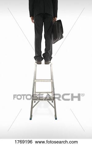 Reaching the top of the corporate ladder View Large Photo Image Stock Photograph - Reaching the top of the corporate ladder. Fotosearch
