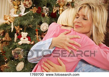 Stock Image - A Christmas morning hug. Fotosearch