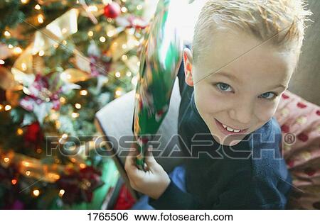 Stock Photograph - Child holds a present. Fotosearch