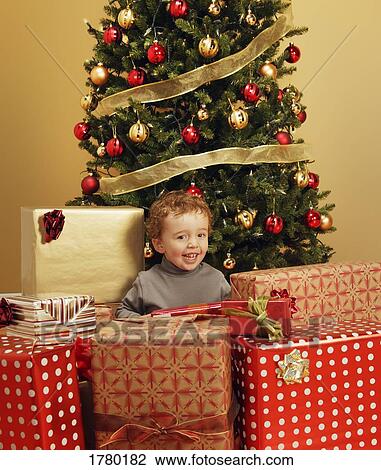 Child under Christmas tree View Large Photo Image Stock Image - Child under Christmas tree. Fotosearch
