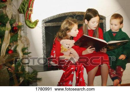 Stock Image - Children reading the Christmas story. Fotosearch