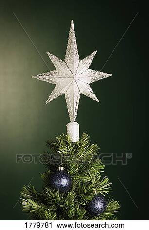 Stock Image - Closeup of a star on Christmas tree. Fotosearch