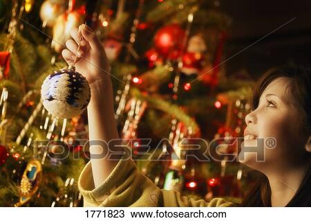 Dressing the Christmas tree View Large Photo Image Stock Image - Dressing the Christmas tree. Fotosearch