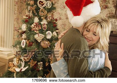 A Christmas morning embrace View Large Photo Image Stock Photograph - A Christmas morning embrace. Fotosearch