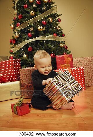 Stock Image - Baby at Christmas time. Fotosearch