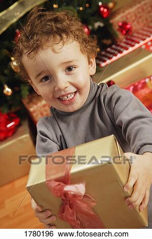 Stock Photograph - Child with Christmas present. Fotosearch