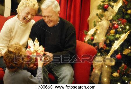Grandparents at Christmas time View Large Photo Image Stock Image - Grandparents at Christmas time. Fotosearch