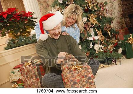 Picture - Opening a present. Fotosearch