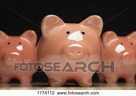 Stock Image - Three pottery pigs. Fotosearch