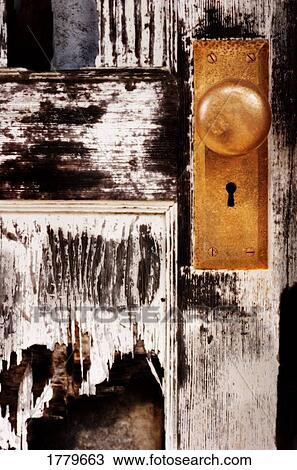 Stock Image - A golden keyhole and door knob. Fotosearch