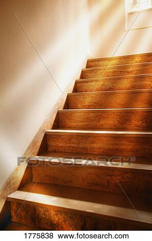Stock Photo - Wooden staircase with beams of light. Fotosearch