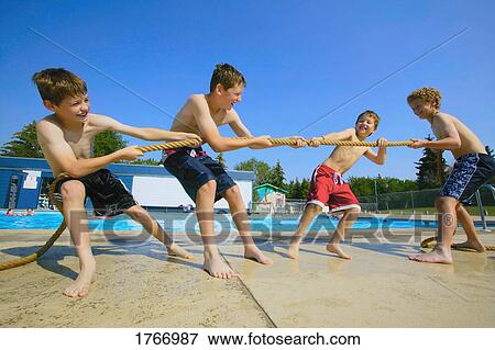 A group of boys play tug of war View Large Photo Image Stock Photo - A group of boys play tug of war. Fotosearch