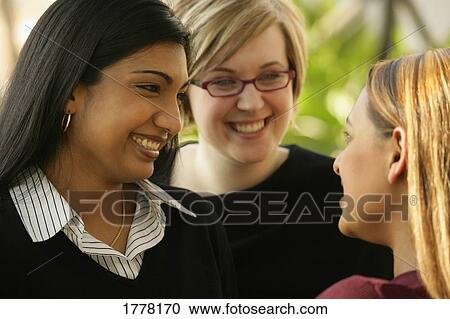 Girlfriends talking View Large Photo Image Stock Image - Girlfriends talking. Fotosearch