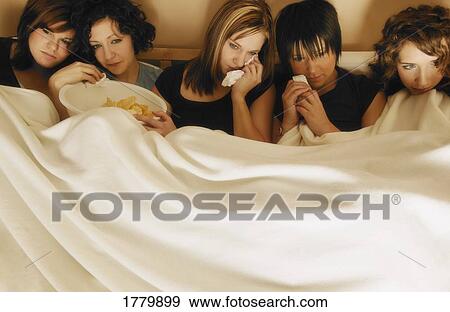 Group of girls watching a sad movie View Large Photo Image Stock Photo - Group of girls watching a sad movie. Fotosearch