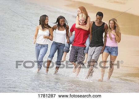 Stock Photo - Group of people at the beach. Fotosearch