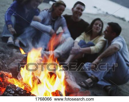 Group sit by campfire View Large Photo Image Stock Photograph - Group sit by campfire. Fotosearch