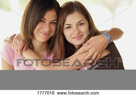 Stock Photograph - Two friends hugging. Fotosearch