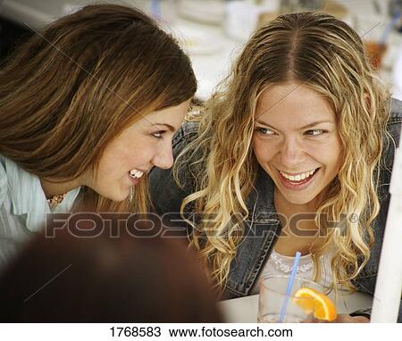 Two girls share a laugh View Large Photo Image Stock Image - Two girls share a laugh. Fotosearch