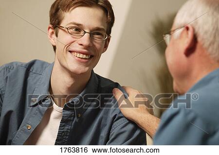 Two people having a conversation View Large Photo Image Stock Photograph - Two people having a conversation. Fotosearch