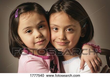 Two sisters hugging View Large Photo Image Stock Image - Two sisters hugging. Fotosearch