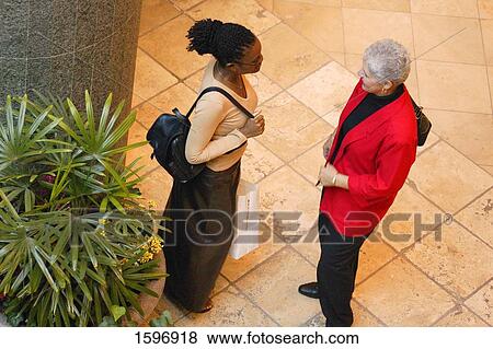 Stock Photo - Two women talking. Fotosearch