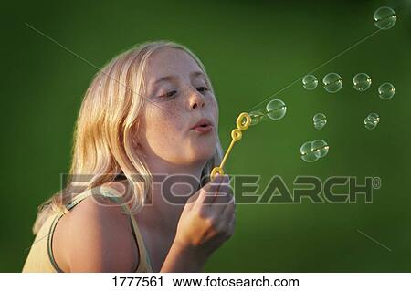 A girl blows bubbles View Large Photo Image Stock Image - A girl blows bubbles. Fotosearch