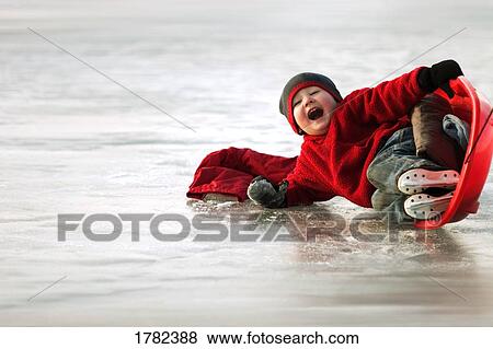 Stock Photo - Boy falls off sled. Fotosearch