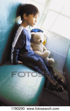 Stock Image - Boy on school bus. Fotosearch