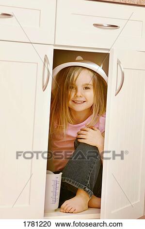 Child hides in kitchen cupboard View Large Photo Image Stock Image - Child hides in kitchen cupboard. Fotosearch