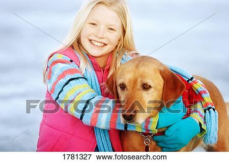 Child hugs dog View Large Photo Image Stock Photo - Child hugs dog. Fotosearch