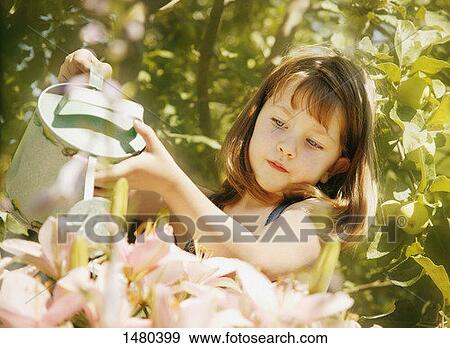 Stock Photo - Child waters flowers. Fotosearch