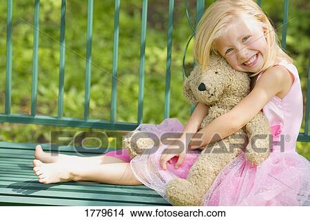 Girl hugs teddy bear View Large Photo Image Picture - Girl hugs teddy bear. Fotosearch