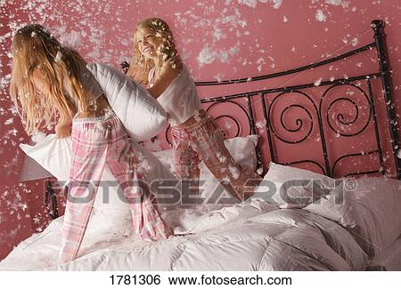 Girls having a pillow fight View Large Photo Image Stock Photograph - Girls having a pillow fight. Fotosearch