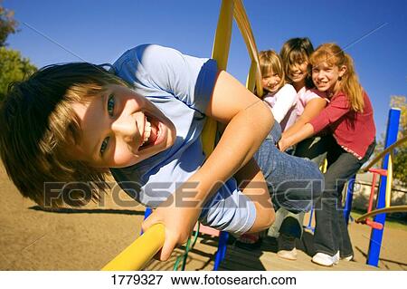 Stock Photo - Girls watch as child hangs on. Fotosearch
