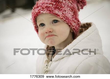 Stock Photo - Little girl outside in the snow. Fotosearch