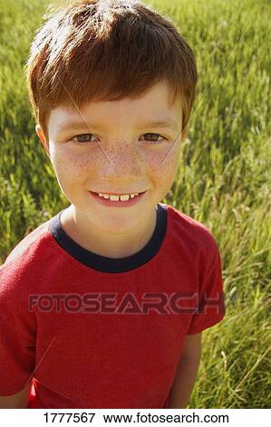 Stock Photo - Portrait of happy smiling boy outside. Fotosearch