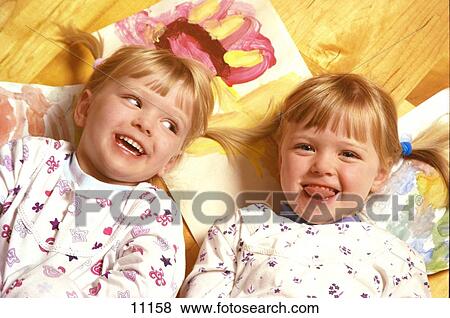 Twin sisters in pyjamas View Large Photo Image Stock Photo - Twin sisters in pyjamas. Fotosearch