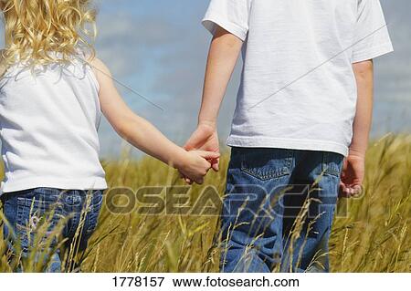 Two kids holding hands View Large Photo Image Stock Photo - Two kids holding hands. Fotosearch