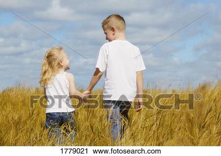 Two young children holding hands View Large Photo Image Stock Image - Two young children holding hands. Fotosearch
